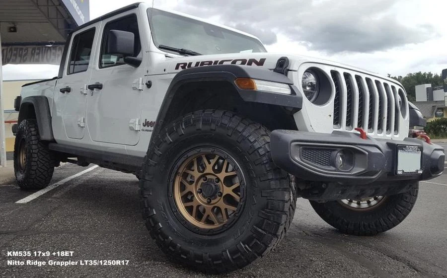 White Jeep Rubicon pickup at Tire Capital in Prince George. Fitted: KM535 17x9 +18ET; Nitto Ridge Grappler LT35/1250R17